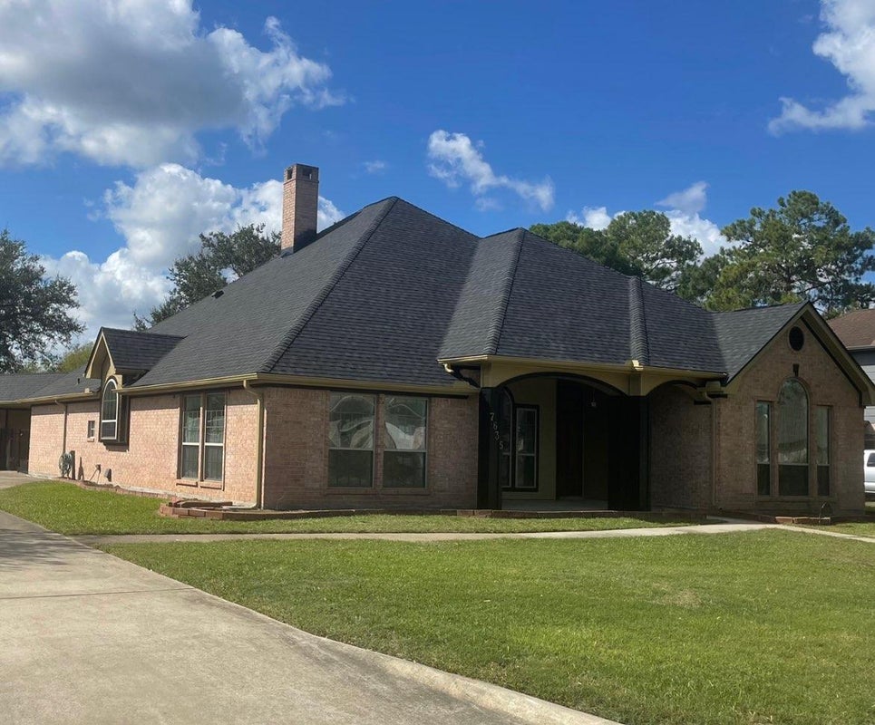 Home with a new roof after complete tear-off by a professional contractor.